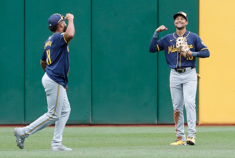 Sep 26, 2024; Pittsburgh, Pennsylvania, USA;  Milwaukee Brewers left fielder Jackson Chourio (11) and center fielder Blake Perkins (16) celebrate in the outfield after defeating the Pittsburgh Pirates at PNC Park. The Brewers won 5-2. Mandatory Credit: Charles LeClaire-Imagn Images