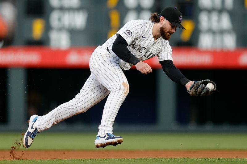 May 7, 2024; Denver, Colorado, USA; Colorado Rockies second baseman Brendan Rodgers (7) fields a hit in the fourth inning against the San Francisco Giants at Coors Field. Mandatory Credit: Isaiah J. Downing-USA TODAY Sports