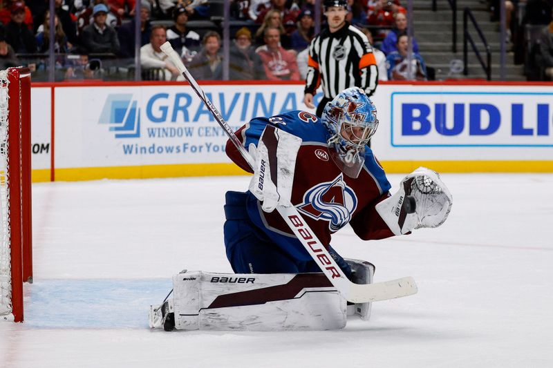 Nov 15, 2024; Denver, Colorado, USA; Colorado Avalanche goaltender Justus Annunen (60) deflects a shot in the first period against the Washington Capitals at Ball Arena. Mandatory Credit: Isaiah J. Downing-Imagn Images