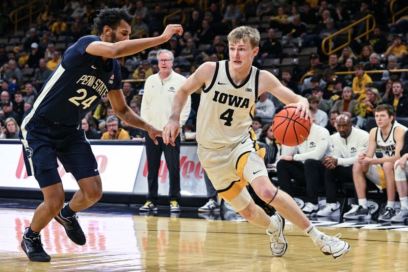 Feb 27, 2024; Iowa City, Iowa, USA; Iowa Hawkeyes guard Josh Dix (4) goes to the basket as Penn State Nittany Lions forward Zach Hicks (24) defends during the second half at Carver-Hawkeye Arena. Mandatory Credit: Jeffrey Becker-USA TODAY Sports