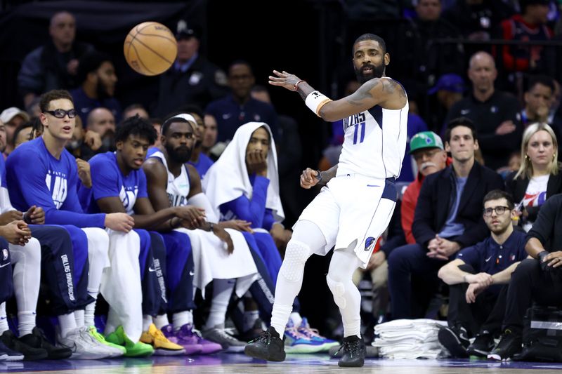 PHILADELPHIA, PENNSYLVANIA - FEBRUARY 05: Kyrie Irving #11 of the Dallas Mavericks passes the ball during the second quarter against the Philadelphia 76ers at the Wells Fargo Center on February 05, 2024 in Philadelphia, Pennsylvania. NOTE TO USER: User expressly acknowledges and agrees that, by downloading and or using this photograph, User is consenting to the terms and conditions of the Getty Images License Agreement. (Photo by Tim Nwachukwu/Getty Images)