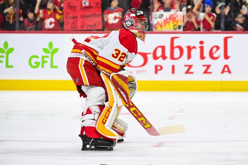 Nov 25, 2024; Ottawa, Ontario, CAN; Calgary Flames goalie Dustin Wolf (32) skates towards his net during warm-up before the game against the Ottawa Senators at Canadian Tire Centre. Mandatory Credit: David Kirouac-Imagn Images