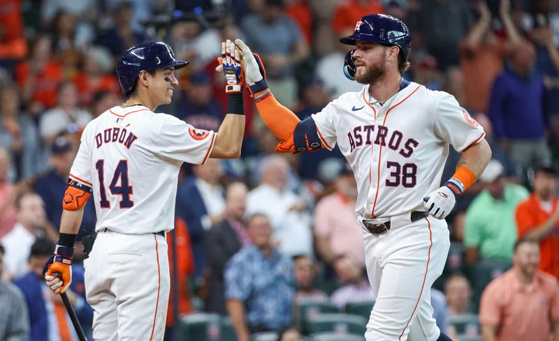 Jun 5, 2024; Houston, Texas, USA; Houston Astros right fielder Trey Cabbage (38) celebrates with third baseman Mauricio Dubon (14) after hitting a home run during the fifth inning against the St. Louis Cardinals at Minute Maid Park. Mandatory Credit: Troy Taormina-USA TODAY Sports