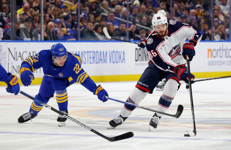 Dec 30, 2023; Buffalo, New York, USA;  Columbus Blue Jackets right wing Kirill Marchenko (86) skates with the puck as Buffalo Sabres right wing Jack Quinn (22) tries to knock the puck off his stick during the third period at KeyBank Center. Mandatory Credit: Timothy T. Ludwig-USA TODAY Sports