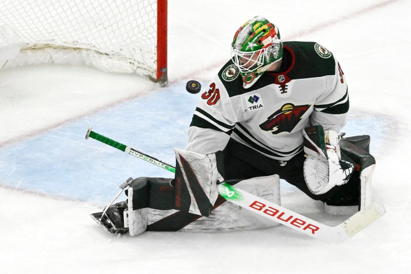 Apr 7, 2024; Chicago, Illinois, USA;  Minnesota Wild goaltender Jesper Wallstedt (30) watches a puck during the third period against the Chicago Blackhawks  at United Center. Mandatory Credit: Matt Marton-USA TODAY Sports