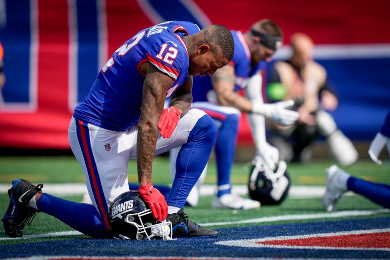 New York Giants tight end Darren Waller (12) kneels in the end zone before an NFL football game against the Washington Commanders, Sunday Oct. 22, 2023, in East Rutherford, N.J. (AP Photo/Bryan Woolston)