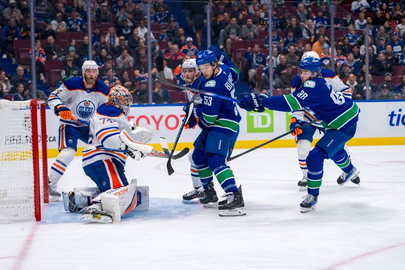 Oct 4, 2024; Vancouver, British Columbia, CAN; Edmonton Oilers forward Connor McDavid (97) battles with Vancouver Canucks forward Teddy Blueger (53) anbd forward Nils Aman (88) as goalie Stuart Skinner (74) makes a save during the first period at Rogers Arena. Mandatory Credit: Bob Frid-Imagn Images