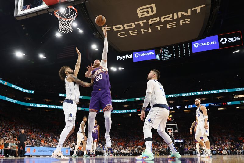 PHOENIX, ARIZONA - OCTOBER 26: Jusuf Nurkic #20 of the Phoenix Suns attempts a shot against Naji Marshall #13 of the Dallas Mavericks during the first half of the NBA game at Footprint Center on October 26, 2024 in Phoenix, Arizona. The Suns defeated the Mavericks 114-102. NOTE TO USER: User expressly acknowledges and agrees that, by downloading and/or using this photograph, user is consenting to the terms and conditions of the Getty Images License Agreement. (Photo by Christian Petersen/Getty Images)