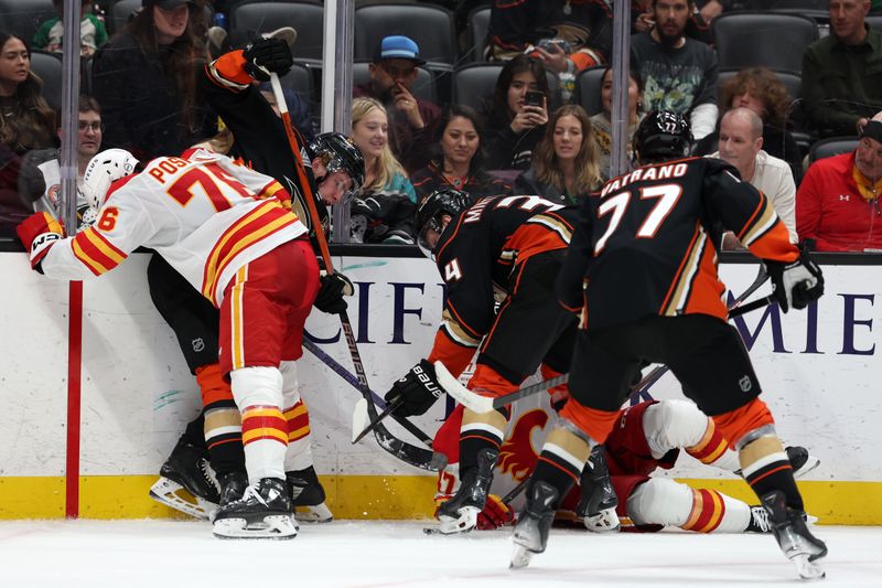 Dec 21, 2023; Anaheim, California, USA;  Calgary Flames center Martin Pospisil (76) and center Connor Zary (47) fight for the puck against Anaheim Ducks defenseman Jackson LaCombe (60) and defenseman Pavel Mintyukov (34) and right wing Frank Vatrano (77) during the third period at Honda Center. Mandatory Credit: Kiyoshi Mio-USA TODAY Sports