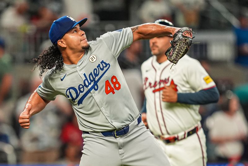Sep 15, 2024; Cumberland, Georgia, USA; Los Angeles Dodgers relief pitcher Brusdar Graterol (48) reacts after the Dodgers defeated the Atlanta Braves at Truist Park. Mandatory Credit: Dale Zanine-Imagn Images