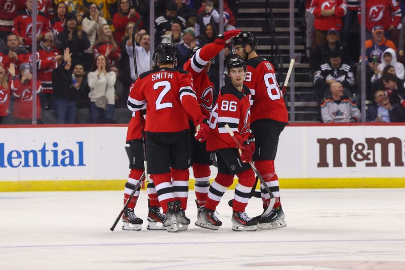 Nov 28, 2023; Newark, New Jersey, USA; New Jersey Devils center Jack Hughes (86) celebrates his goal against the New York Islanders during the third period at Prudential Center. Mandatory Credit: Ed Mulholland-USA TODAY Sports