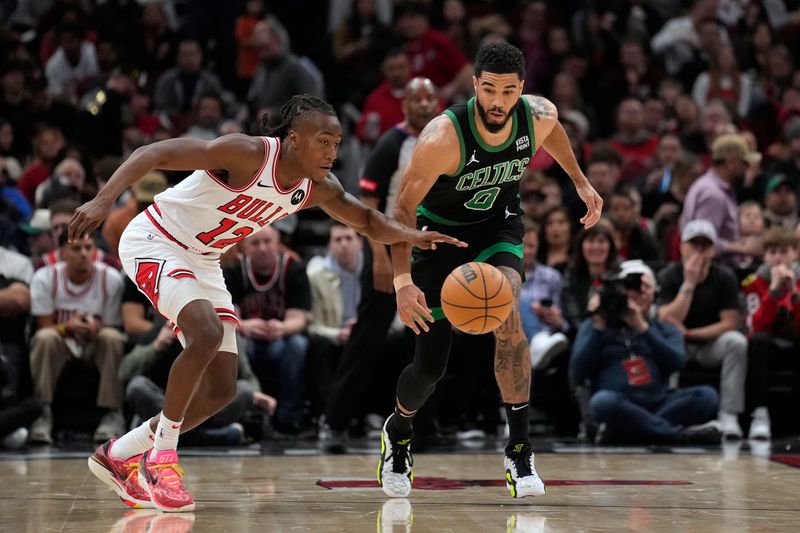 CHICAGO, ILLINOIS - FEBRUARY 22: Jayson Tatum #0 of the Boston Celtics and Ayo Dosunmu #12 of the Chicago Bulls go for the ball during the first half at the United Center on February 22, 2024 in Chicago, Illinois. NOTE TO USER: User expressly acknowledges and agrees that, by downloading and or using this photograph, User is consenting to the terms and conditions of the Getty Images License Agreement. (Photo by Patrick McDermott/Getty Images)