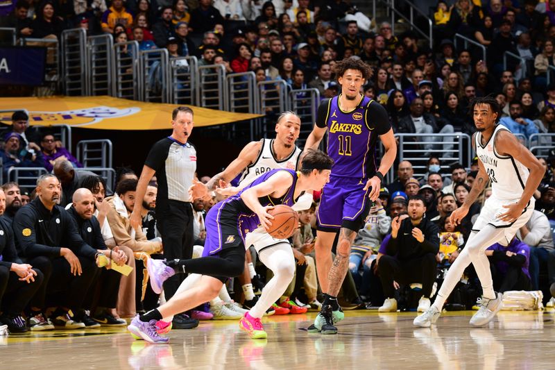 LOS ANGELES, CA - JANUARY 17: Austin Reaves #15 of the Los Angeles Lakers dribbles the ball during the game against the Brooklyn Nets on January 17, 2025 at Crypto.Com Arena in Los Angeles, California. NOTE TO USER: User expressly acknowledges and agrees that, by downloading and/or using this Photograph, user is consenting to the terms and conditions of the Getty Images License Agreement. Mandatory Copyright Notice: Copyright 2025 NBAE (Photo by Adam Pantozzi/NBAE via Getty Images)