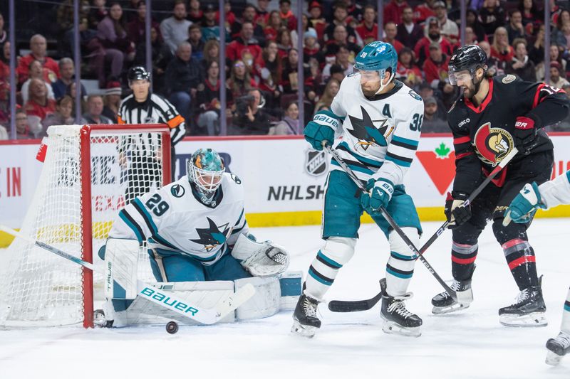 Jan 13, 2024; Ottawa, Ontario, CAN; San Jose Sharks goalie Mackenzie Blackwood (29) makes a save in front of Ottawa Senators center Mark Kastelic (12) in the first period at the Canadian Tire Centre. Mandatory Credit: Marc DesRosiers-USA TODAY Sports