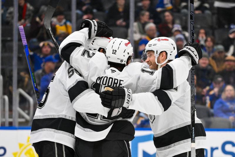 Jan 24, 2026; St. Louis, Missouri, USA; Los Angeles Kings left wing Trevor Moore (12) is congratulated by right wing Quinton Byfield (55) and right wing Joel Armia (40) after scoring against the St. Louis Blues during the third period at Enterprise Center. Mandatory Credit: Jeff Curry-Imagn Images