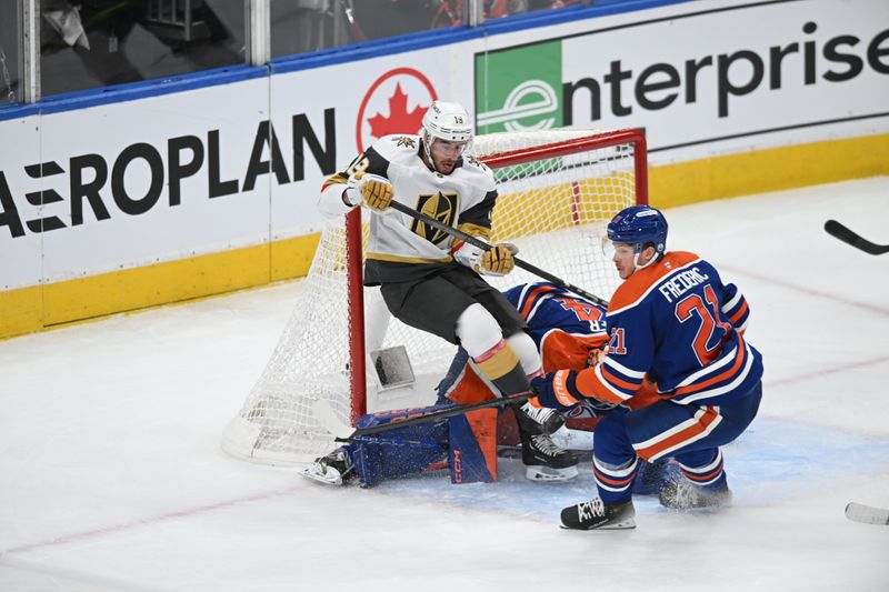 May 10, 2025; Edmonton, Alberta, CAN; Edmonton Oilers goalie Stuart Skinner (74) battles for the puck with Vegas Golden Knights right winger Reilly Smith (19) with Oilers centre Brett Frederic (21) looking on during the first period in game three of the second round of the 2025 Stanley Cup Playoffs at Rogers Place. Mandatory Credit: Walter Tychnowicz-Imagn Images