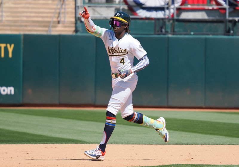 Jul 4, 2024; Oakland, California, USA; Oakland Athletics right fielder Lawrence Butler (4) gestures as he rounds the bases on a solo home run against the Los Angeles Angels during the eighth inning at Oakland-Alameda County Coliseum. Mandatory Credit: Kelley L Cox-USA TODAY Sports