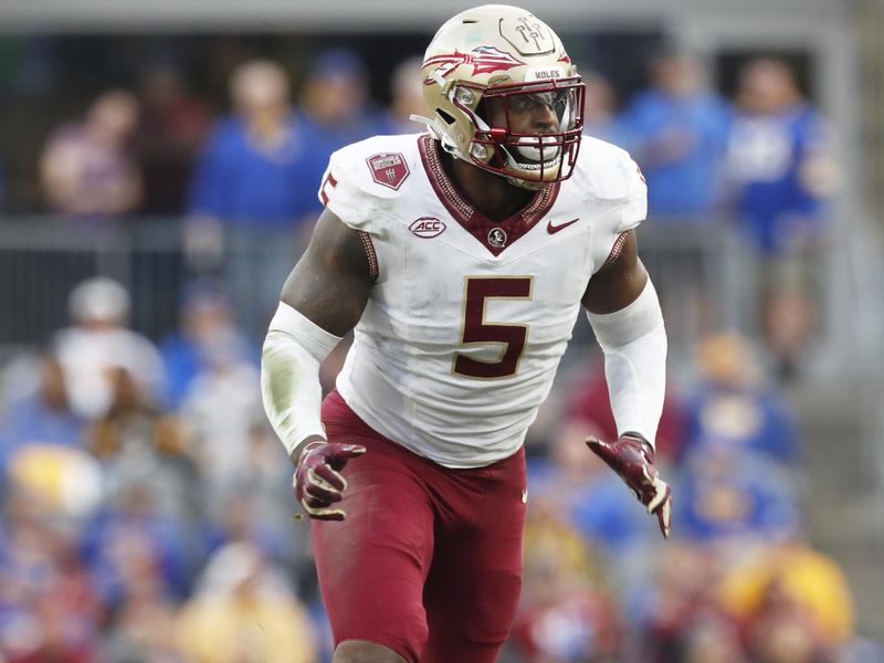 Nov 4, 2023; Pittsburgh, Pennsylvania, USA;  Florida State Seminoles defensive lineman Jared Verse (5) breaks off of the line of scrimmage against the Pittsburgh Panthers during the second quarter at Acrisure Stadium. Mandatory Credit: Charles LeClaire-USA TODAY Sports