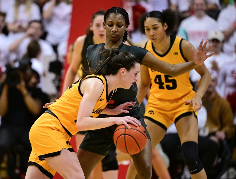 Feb 22, 2024; Bloomington, Indiana, USA; Indiana Hoosiers guard Chloe Moore-McNeil (22) defends against Iowa Hawkeyes guard Caitlin Clark (22) during the second half at Simon Skjodt Assembly Hall. Mandatory Credit: Marc Lebryk-USA TODAY Sports