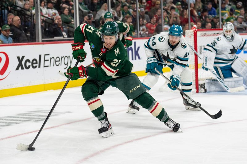 Mar 3, 2024; Saint Paul, Minnesota, USA; Minnesota Wild right wing Brandon Duhaime (21) controls the puck, defended by San Jose Sharks defenseman Marc-Edouard Vlasic (44) in the second period at Xcel Energy Center. Mandatory Credit: Matt Blewett-USA TODAY Sports