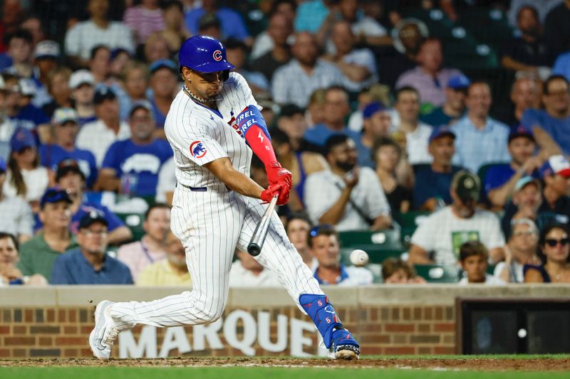 Jun 17, 2024; Chicago, Illinois, USA; Chicago Cubs third baseman Christopher Morel (5) singles against the San Francisco Giants during the fifth inning at Wrigley Field. Mandatory Credit: Kamil Krzaczynski-USA TODAY Sports