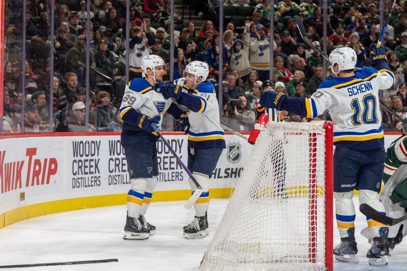 Jan 7, 2025; Saint Paul, Minnesota, USA; St. Louis Blues left wing Pavel Buchnevich (89) is congratulated by teammates center Dylan Holloway (81) and center Brayden Schenn (10) after scoring against the Minnesota Wild in the first period at Xcel Energy Center. Mandatory Credit: Matt Blewett-Imagn Images