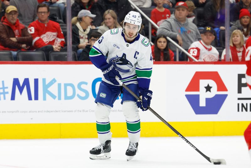 Dec 1, 2024; Detroit, Michigan, USA;  Vancouver Canucks defenseman Quinn Hughes (43) skates with the puck in the first period against the Detroit Red Wings at Little Caesars Arena. Mandatory Credit: Rick Osentoski-Imagn Images