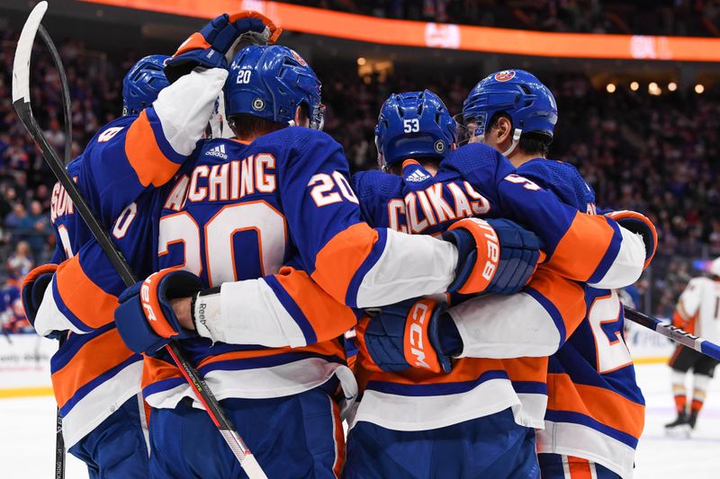 Dec 13, 2023; Elmont, New York, USA; New York Islanders right wing Hudson Fasching (20) and New York Islanders defenseman Alexander Romanov (28) celebrates the goal by New York Islanders center Casey Cizikas (53) against the Anaheim Ducks during the second period at UBS Arena. Mandatory Credit: Dennis Schneidler-USA TODAY Sports