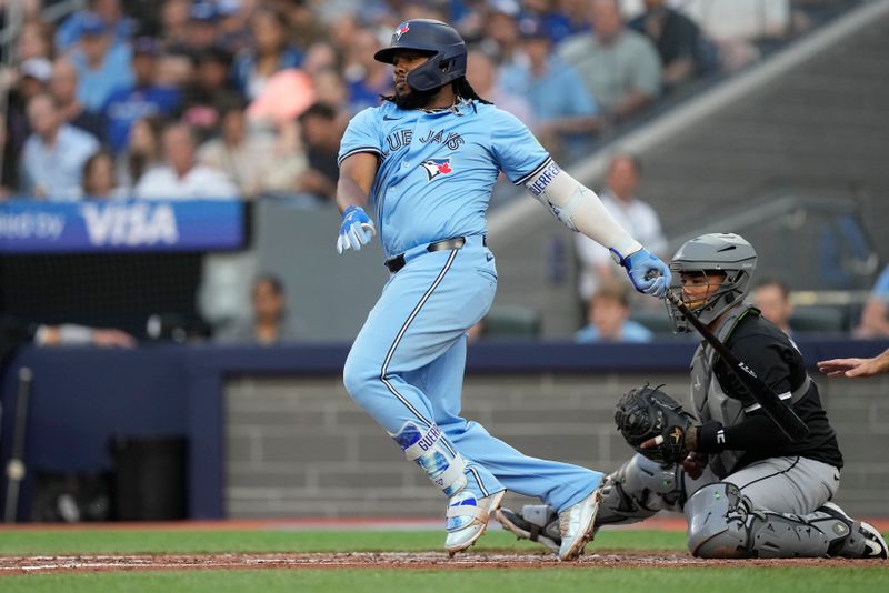 May 22, 2024; Toronto, Ontario, CAN; Toronto Blue Jays first baseman Vladimir Guerrero Jr. (27) hits a RBI single against the Chicago White Sox during the second inning at Rogers Centre. Mandatory Credit: John E. Sokolowski-USA TODAY Sports