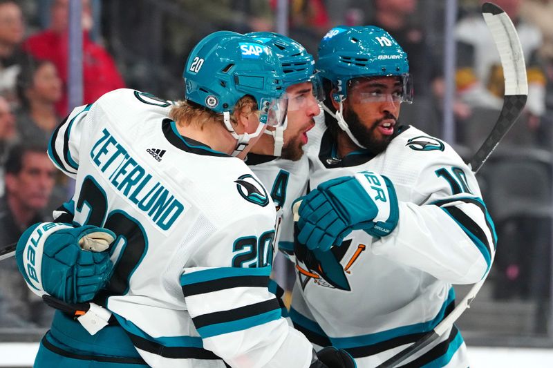 Dec 10, 2023; Las Vegas, Nevada, USA; San Jose Sharks defenseman Mario Ferraro (38) celebrates with left wing Anthony Duclair (10) and left wing Fabian Zetterlund (20) after scoring a goal against the Vegas Golden Knights during the first period at T-Mobile Arena. Mandatory Credit: Stephen R. Sylvanie-USA TODAY Sports