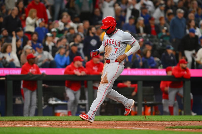 Jul 22, 2024; Seattle, Washington, USA; Los Angeles Angels right fielder Jo Adell (7) scores a run against the Seattle Mariners during the eighth inning at T-Mobile Park. Mandatory Credit: Steven Bisig-USA TODAY Sports