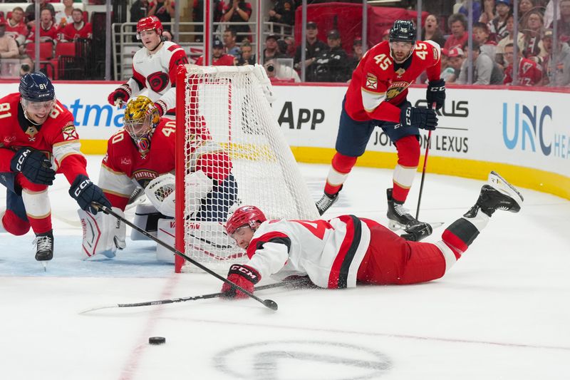 Sep 24, 2025; Raleigh, North Carolina, USA;  Carolina Hurricanes center Ivan Ryabkin (49) can’t get the puck against Florida Panthers goaltender Daniil Tarasov (40) during the third period at Lenovo Center. Mandatory Credit: James Guillory-Imagn Images