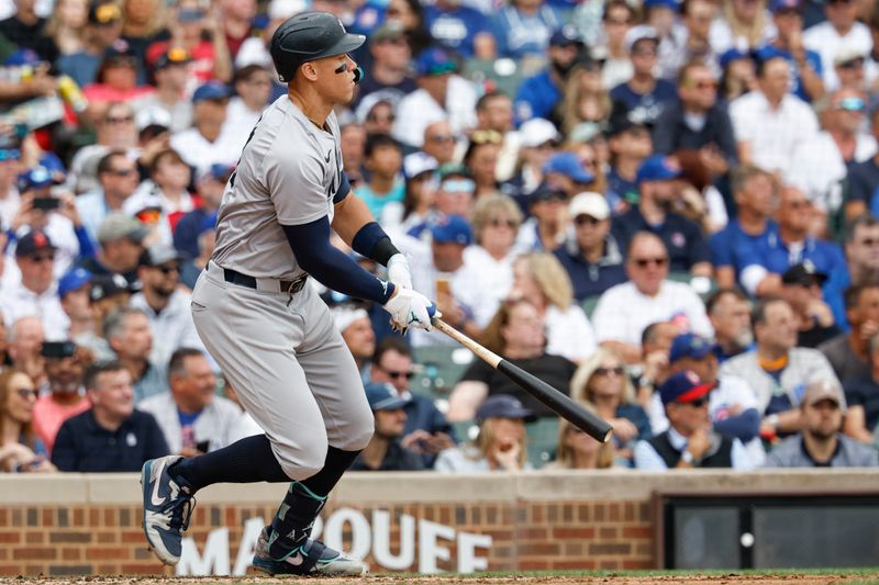 Sep 6, 2024; Chicago, Illinois, USA; New York Yankees outfielder Aaron Judge (99) hits an RBI-double against the Chicago Cubs during the third inning at Wrigley Field. Mandatory Credit: Kamil Krzaczynski-Imagn Images