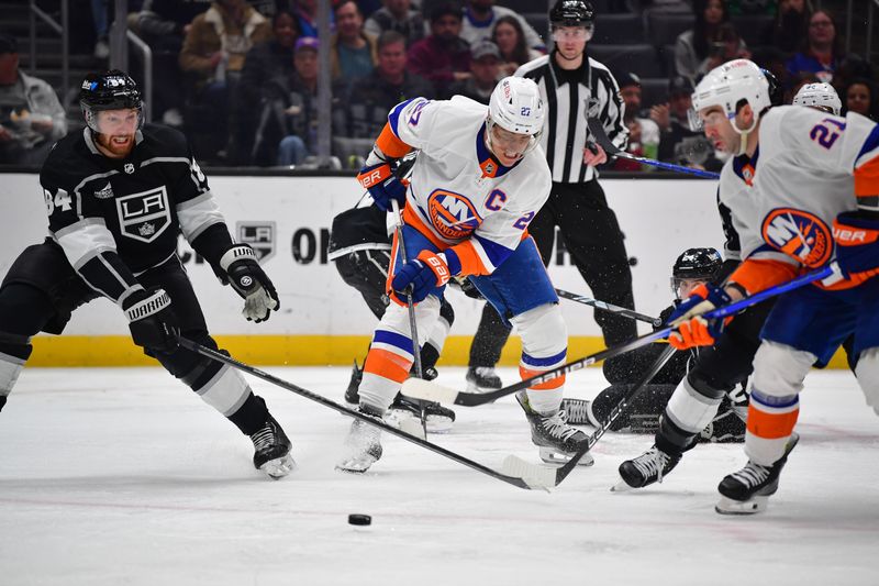 Mar 11, 2024; Los Angeles, California, USA; New York Islanders left wing Anders Lee (27) plays for the puck against Los Angeles Kings defenseman Vladislav Gavrikov (84) during the third period at Crypto.com Arena. Mandatory Credit: Gary A. Vasquez-USA TODAY Sports