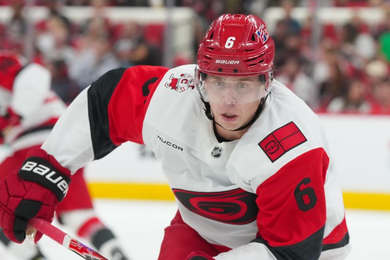Sep 24, 2025; Raleigh, North Carolina, USA;  Carolina Hurricanes defenseman Mike Reilly (6) skaters against the Florida Panthers during the second period at Lenovo Center. Mandatory Credit: James Guillory-Imagn Images