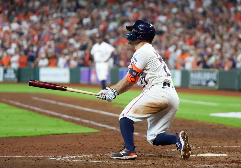 Apr 13, 2024; Houston, Texas, USA; Houston Astros second base Jose Altuve (27) hits a two-run RBI double against the Texas Rangers in the seventh inning at Minute Maid Park. Mandatory Credit: Thomas Shea-USA TODAY Sports