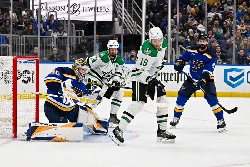 Dec 27, 2023; St. Louis, Missouri, USA;  St. Louis Blues goaltender Joel Hofer (30) defends the net against Dallas Stars center Joe Pavelski (16) and left wing Jamie Benn (14) during the third period at Enterprise Center. Mandatory Credit: Jeff Curry-USA TODAY Sports