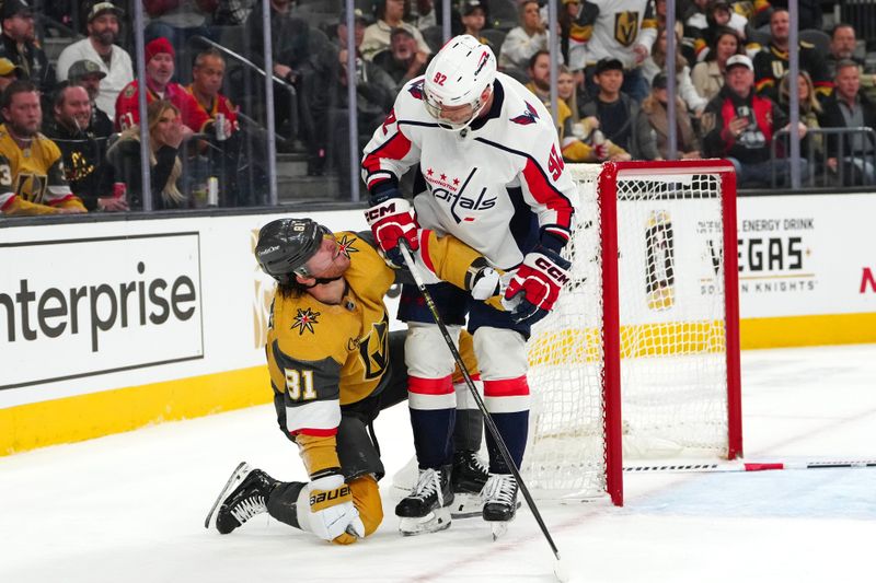 Dec 2, 2023; Las Vegas, Nevada, USA; Vegas Golden Knights right wing Jonathan Marchessault (81) gets his stick tangled in the equipment of Washington Capitals center Evgeny Kuznetsov (92) during the second period at T-Mobile Arena. Mandatory Credit: Stephen R. Sylvanie-USA TODAY Sports