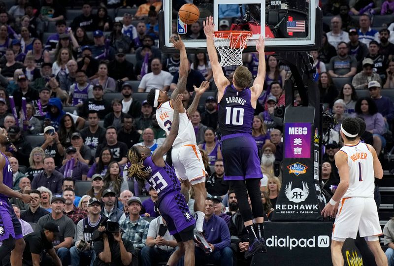 SACRAMENTO, CALIFORNIA - APRIL 12: Bradley Beal #3 of the Phoenix Suns shoots and scores over Domantas Sabonis during the second half at Golden 1 Center on April 12, 2024 in Sacramento, California. NOTE TO USER: User expressly acknowledges and agrees that, by downloading and or using this photograph, User is consenting to the terms and conditions of the Getty Images License Agreement. (Photo by Thearon W. Henderson/Getty Images)