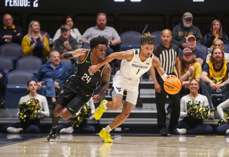 Feb 20, 2024; Morgantown, West Virginia, USA; West Virginia Mountaineers guard Noah Farrakhan (1) dribbles the ball past UCF Knights guard Jaylin Sellers (24) during the second half at WVU Coliseum. Mandatory Credit: Ben Queen-USA TODAY Sports