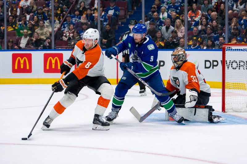 Oct 11, 2024; Vancouver, British Columbia, CAN; Philadelphia Flyers goalie Samuel Ersson (33) watches as Vancouver Canucks forward J.T. Miller (9) battles with defenseman Cam York (8) during the third period at Rogers Arena. Mandatory Credit: Bob Frid-Imagn Images