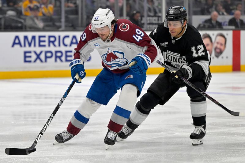 Apr 12, 2025; Los Angeles, California, USA; Colorado Avalanche defenseman Samuel Girard (49) controls the puck away from Los Angeles Kings left wing Trevor Moore (12) in the second period at Crypto.com Arena. Mandatory Credit: Jayne Kamin-Oncea-Imagn Images