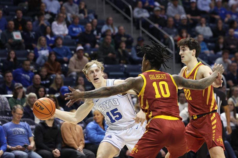 Jan 16, 2024; Provo, Utah, USA; Brigham Young Cougars guard Richie Saunders (15) passes the ball past Iowa State Cyclones guard Keshon Gilbert (10) and forward Milan Momcilovic (22) during the first half at Marriott Center. Mandatory Credit: Rob Gray-USA TODAY Sports