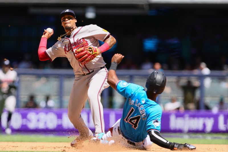 Apr 14, 2024; Miami, Florida, USA; Atlanta Braves shortstop Orlando Arcia (11) throws to first base but cannot turn a double play against the Miami Marlins during the fourth inning at loanDepot Park. Mandatory Credit: Sam Navarro-USA TODAY Sports