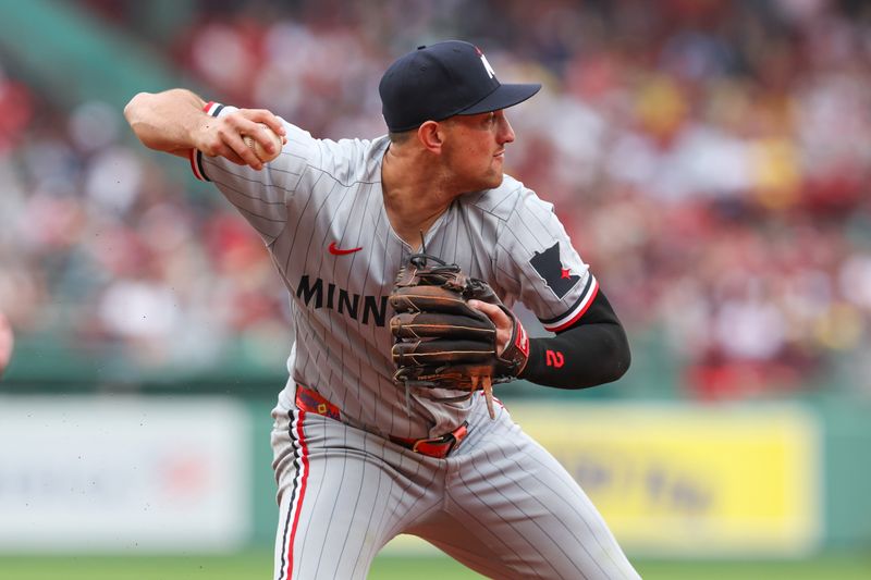 May 4, 2025; Boston, Massachusetts, USA; Minnesota Twins second baseman Brooks Lee (2) throws to first base during the ninth inning against the Boston Red Sox at Fenway Park. Mandatory Credit: Paul Rutherford-Imagn Images
