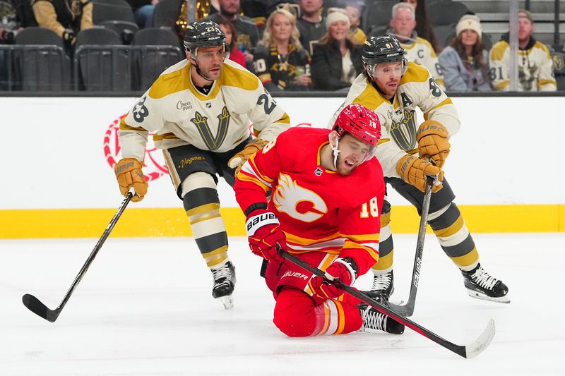 sJan 13, 2024; Las Vegas, Nevada, USA; Calgary Flames left wing A.J. Greer (18) is tripped in front of Vegas Golden Knights defenseman Alec Martinez (23) and Vegas Golden Knights right wing Jonathan Marchessault (81) during the first period at T-Mobile Arena. Mandatory Credit: Stephen R. Sylvanie-USA TODAY Sports