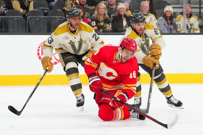 sJan 13, 2024; Las Vegas, Nevada, USA; Calgary Flames left wing A.J. Greer (18) is tripped in front of Vegas Golden Knights defenseman Alec Martinez (23) and Vegas Golden Knights right wing Jonathan Marchessault (81) during the first period at T-Mobile Arena. Mandatory Credit: Stephen R. Sylvanie-USA TODAY Sports