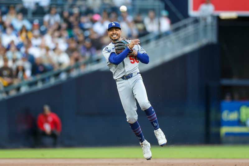 Jun 9, 2025; San Diego, California, USA; Los Angeles Dodgers shortstop Mookie Betts (50) makes the throw to first for an out during the first inning against the San Diego Padres at Petco Park. Mandatory Credit: David Frerker-Imagn Images