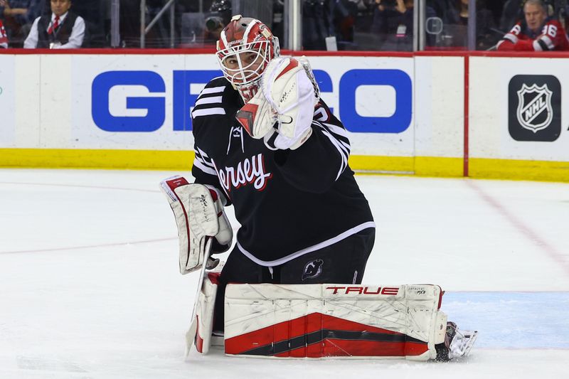 Jan 6, 2024; Newark, New Jersey, USA; New Jersey Devils goaltender Nico Daws (50) makes a save against the Vancouver Canucks during the third period at Prudential Center. Mandatory Credit: Ed Mulholland-USA TODAY Sports