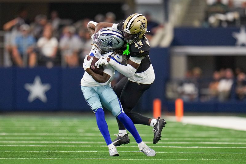 Dallas Cowboys wide receiver KaVontae Turpin, left, is wrapped up by New Orleans Saints cornerback Kool-Aid McKinstry during the first half of an NFL football game, Sunday, Sept. 15, 2024, in Arlington, Texas. (AP Photo/Jeffrey McWhorter)